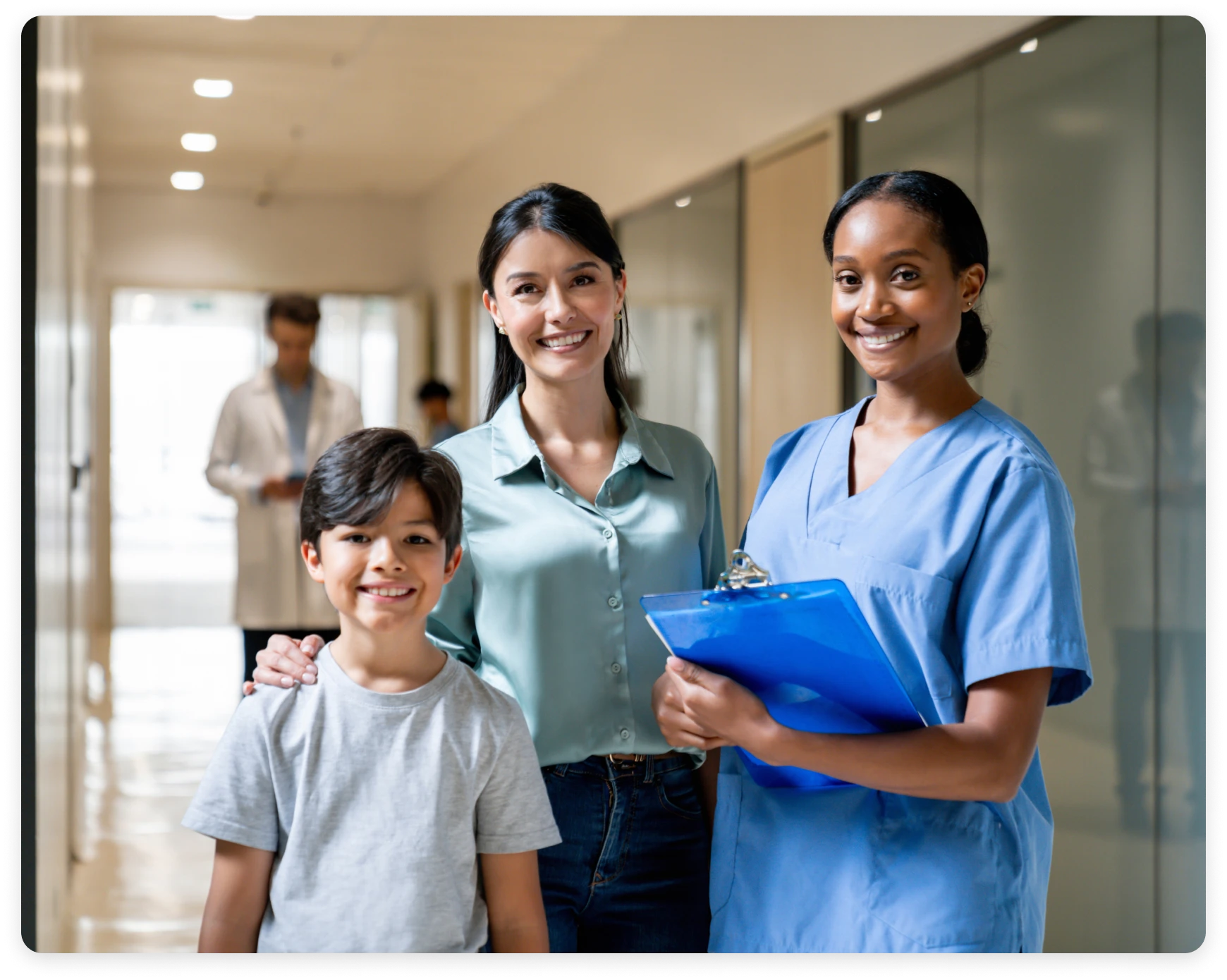 Mother, child, and nurse in hospital corridor.